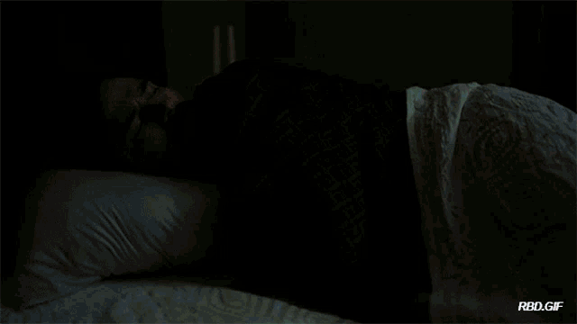 a man and a woman are laying in bed with a rbd.gif watermark