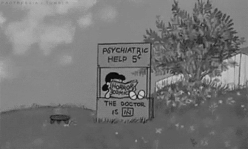 a black and white cartoon of charlie brown and lucy brown standing in front of a psychiatric help stand .