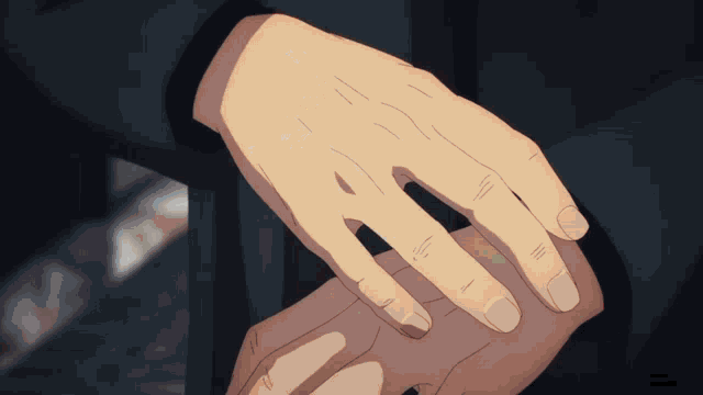 a person holding another person 's hand with a black shirt on