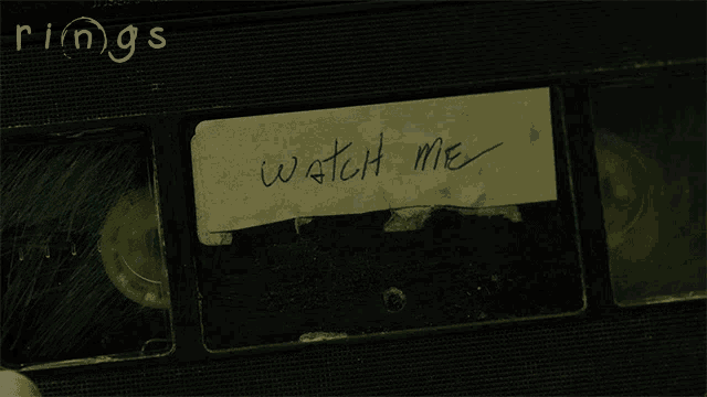 a piece of paper that says watch me is on a vhs tape