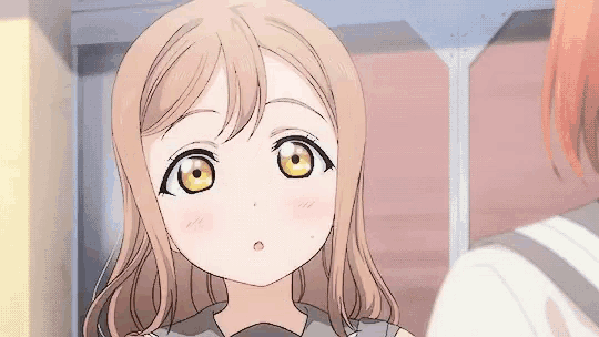 a close up of a girl 's face with yellow eyes and a surprised look on her face .
