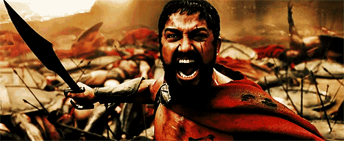 a man with a beard is holding a sword in his hand