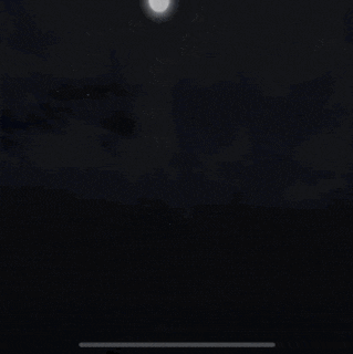 a screenshot of a video game shows a robot in the dark