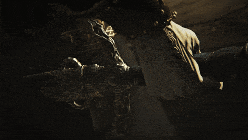 a person is holding a sword in their hand