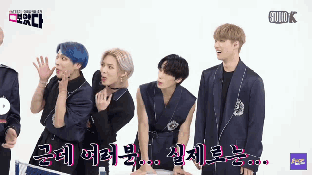 a group of young men standing next to each other with studio k on the bottom left