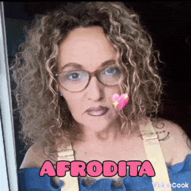 a woman with curly hair is wearing glasses and the word afrodita is above her