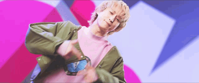 a man in a pink sweater and green jacket is dancing