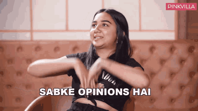 a woman sitting in a chair with the words sabke opinions hai written on the bottom