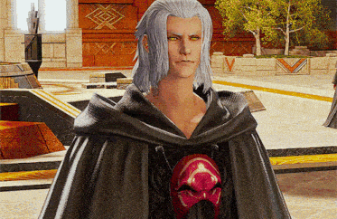 a man with gray hair is wearing a black cape