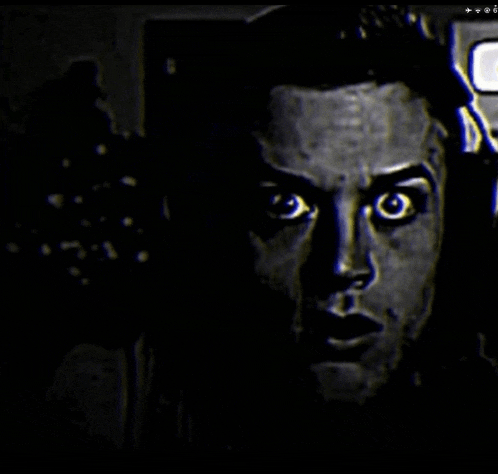 a close up of a man 's face in the dark