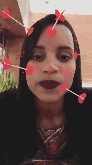 a woman with arrows in her face and hearts around her