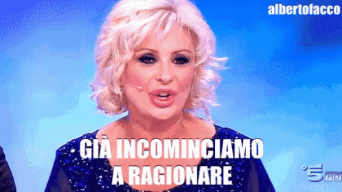 a woman in a blue dress says già incominciamo a ragionere