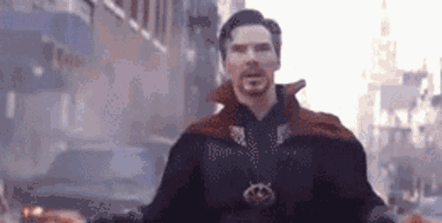 doctor strange is standing in the middle of a city street .