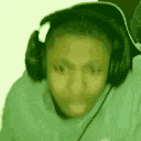 a person wearing headphones and a green shirt is making a funny face .