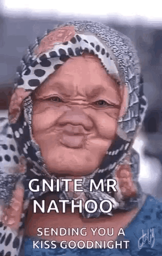 an older woman wearing a scarf around her head is making a funny face .