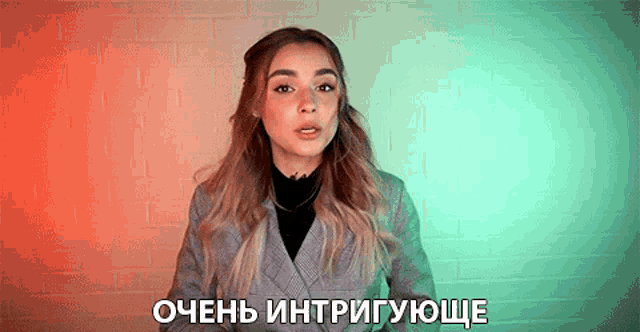 a woman is standing in front of a brick wall and says " очень "