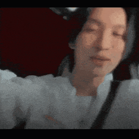 a close up of a person taking a selfie with their eyes closed