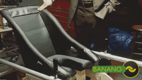 a man standing next to a chair that says banana
