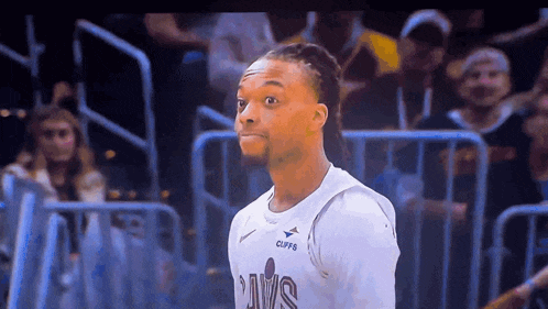 a man wearing a cavs jersey looks surprised