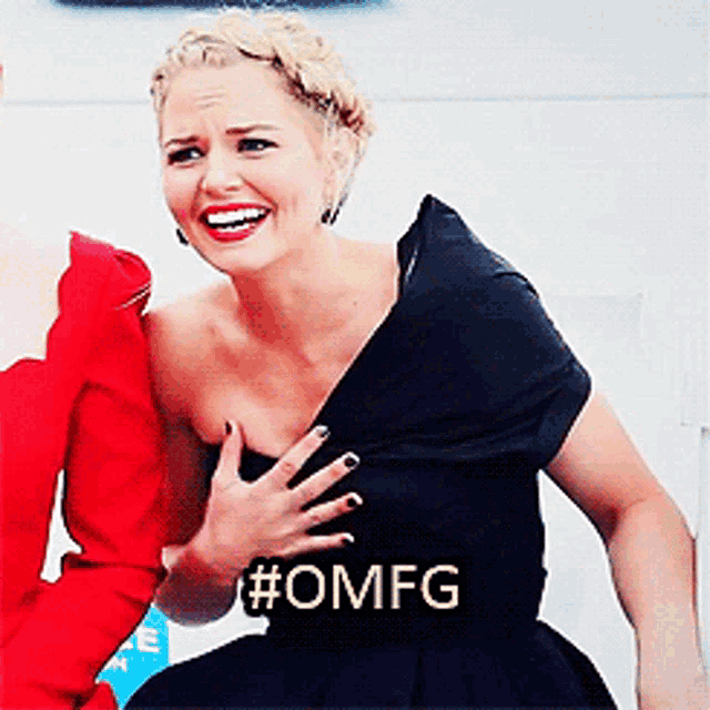 a woman in a black dress with #omfg on her chest