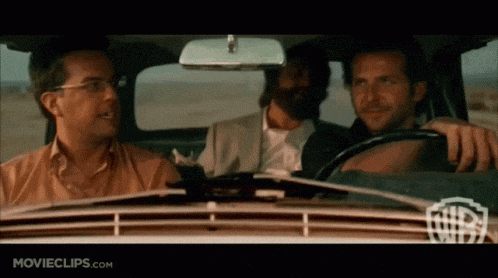 three men are sitting in a car with movieclips.com written on the bottom right