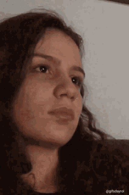 a close up of a woman 's face with the words gifsdayrol at the bottom