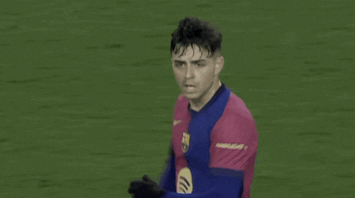a soccer player is standing on a field wearing a nike jersey .
