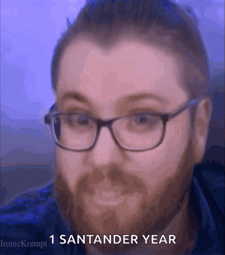 a man with glasses and a beard has the words 1 santander year on his face