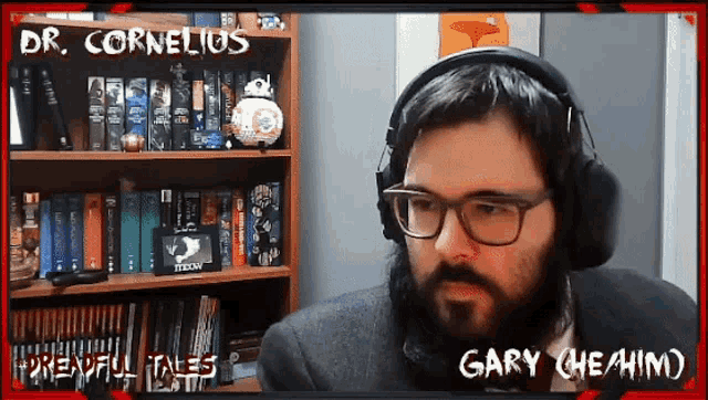 a man with glasses and headphones is sitting in front of a bookshelf with the name gary on it