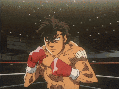 a man in boxing gloves stands in a ring