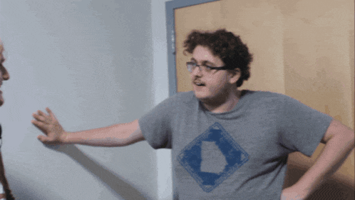 a man wearing a grey shirt with a map of louisiana on it