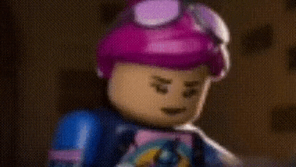 a close up of a lego girl with purple hair wearing a helmet and goggles .