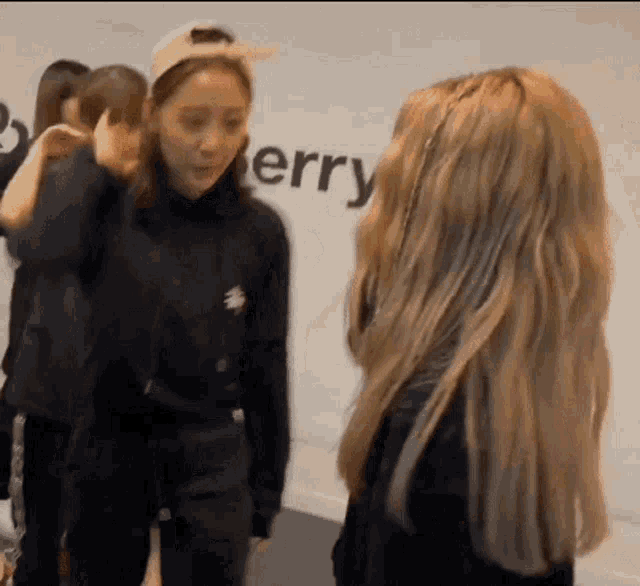 a group of women are standing next to each other in front of a wall that says erry