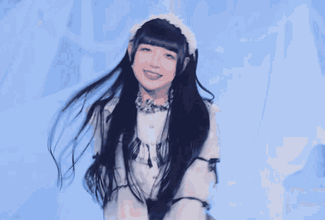 a girl with long black hair is wearing a dress and a headband