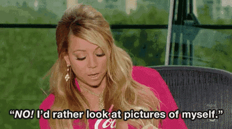 a woman is sitting in a chair and saying `` no ! i 'd rather look at pictures of myself ''