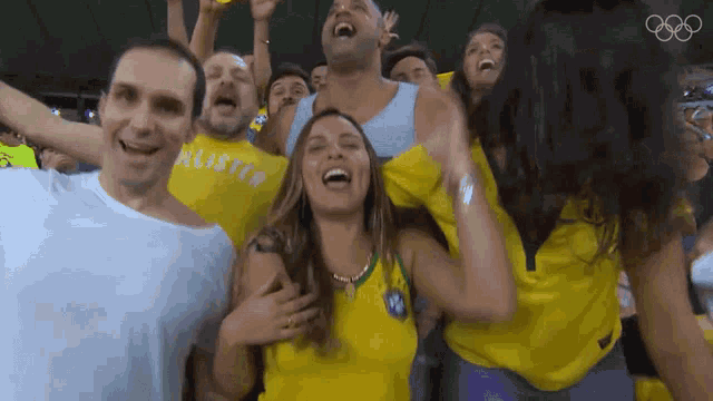 a group of people in yellow shirts with hollister on them