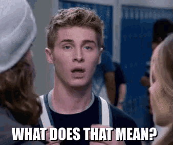 a young man is talking to a group of people in a locker room and the words `` what does that mean '' are above him .