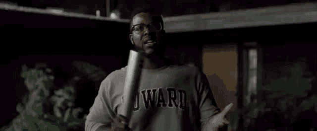 a man in a howard shirt is holding a baseball bat and says we can get crazy