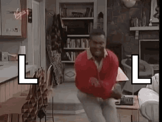 a man in a red sweater is jumping in a living room .