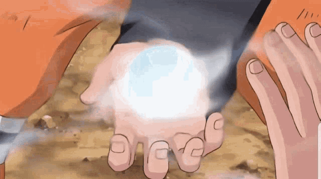 a person holding a ball in their hands with a smoke coming out of it