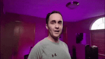 a man is smiling and giving a thumbs up .