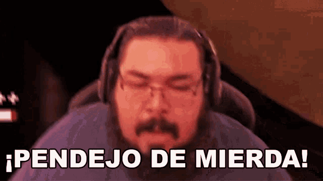 a man wearing headphones and glasses is saying pendejo de mierda