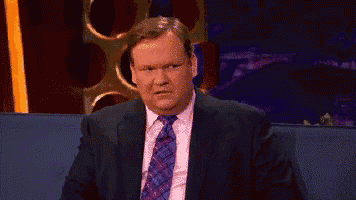 a man in a suit and tie is sitting down