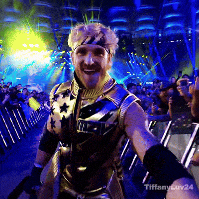 a man wearing a gold vest with stars on it is smiling in front of a crowd with tiffany luv24 written on the bottom