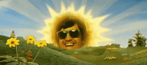 a man wearing sunglasses is standing in front of a sun in a field of flowers
