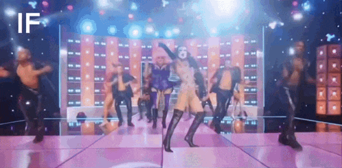 a group of people are dancing on a stage with the word if in the corner