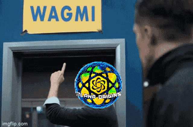 a man is pointing to a sign that says wagmi