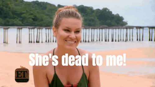 a woman on a beach with the words she 's dead to me on the bottom