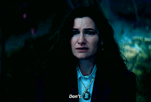 a woman wearing a necklace that says " do n't " on it