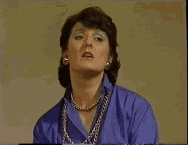 a woman in a blue shirt and pearls says sexual problems